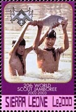 Scouts in water holding fish